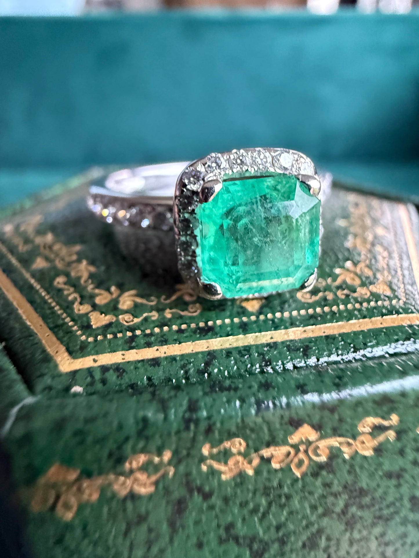 18ct gold emerald and diamond halo ring