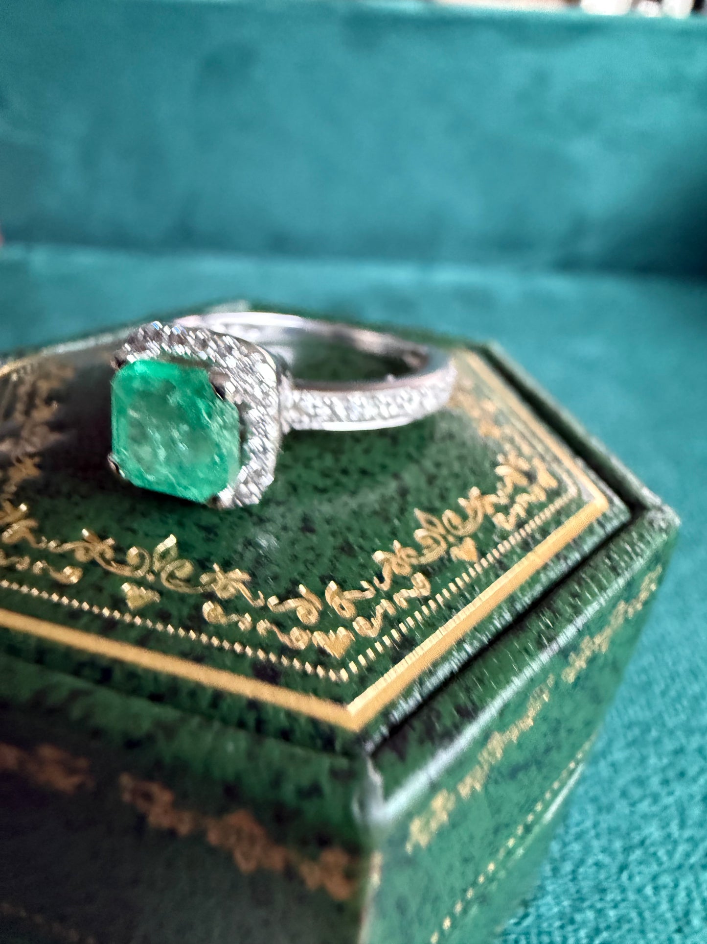 18ct gold emerald and diamond halo ring