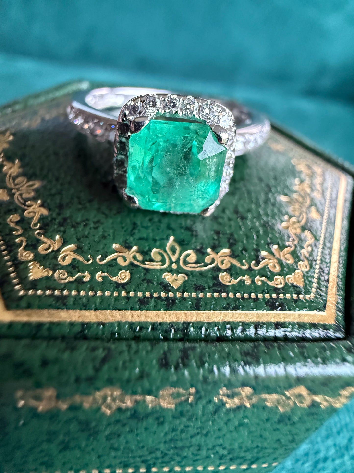 18ct gold emerald and diamond halo ring