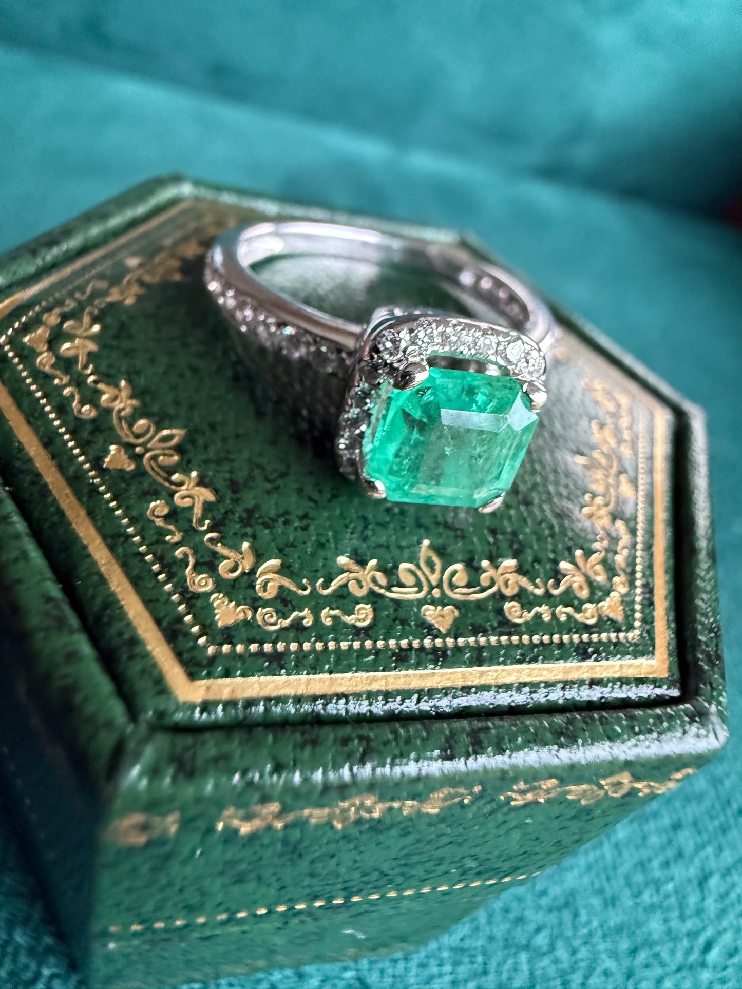 18ct gold emerald and diamond halo ring